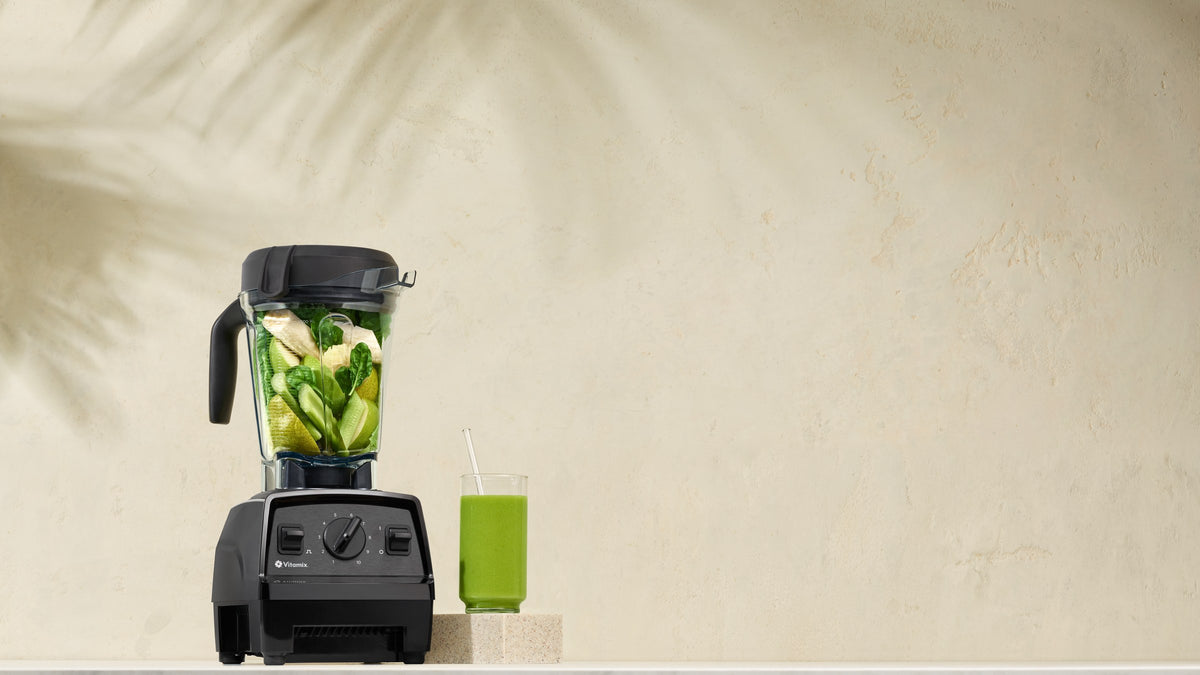 Vitamix Explorian E320 mit gruenem Smoothie vor heller Wand